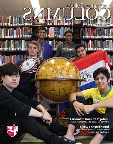 LaGrange College Columns featuring six international students sitting in the library stacks with a large globe